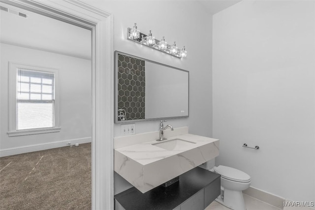 bathroom featuring vanity, toilet, baseboards, and visible vents