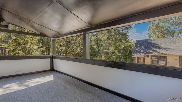 unfurnished sunroom featuring a wealth of natural light and lofted ceiling