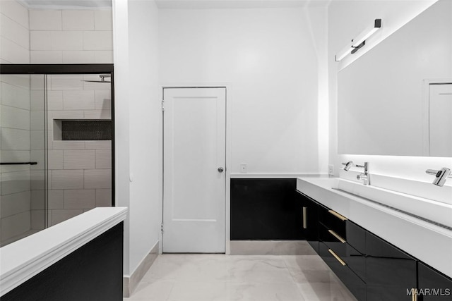full bath with baseboards, a shower stall, marble finish floor, and vanity