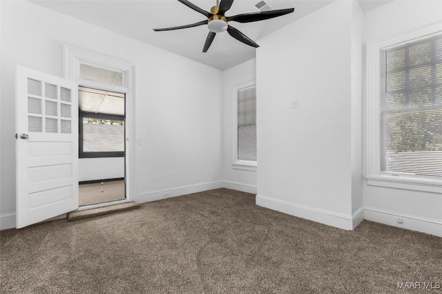 unfurnished room with a ceiling fan, carpet, and a healthy amount of sunlight