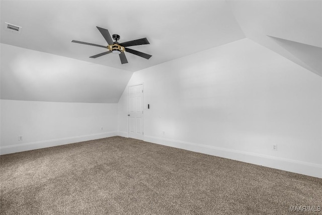 additional living space with lofted ceiling, visible vents, carpet floors, baseboards, and ceiling fan