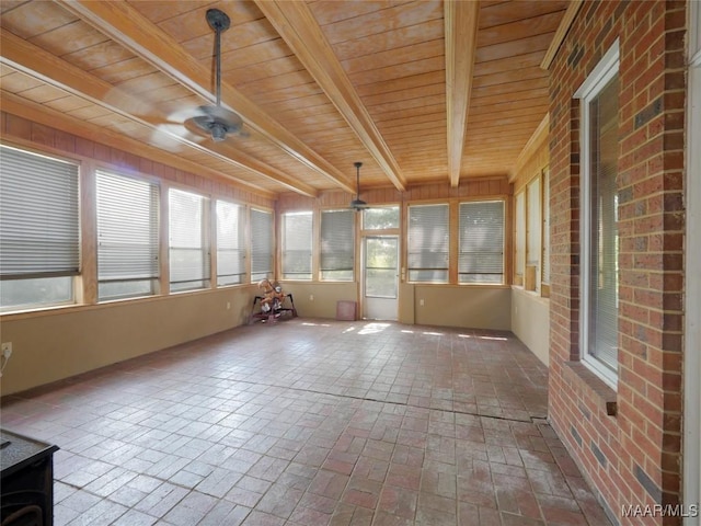 unfurnished sunroom featuring beamed ceiling, brick floor, and wooden ceiling