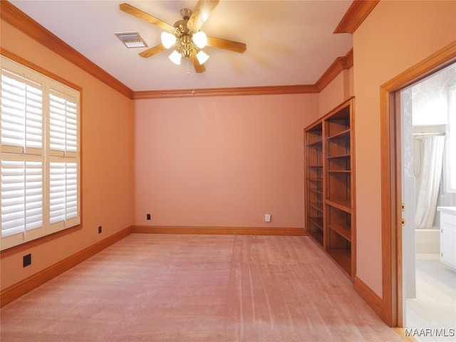 carpeted spare room with ornamental molding and ceiling fan