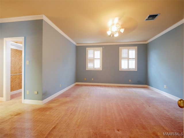 spare room with ceiling fan, crown molding, and light carpet