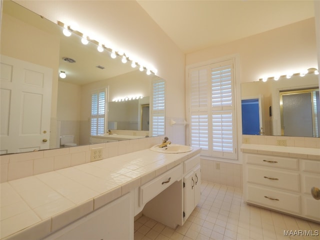 bathroom with vanity, tile patterned flooring, and plenty of natural light