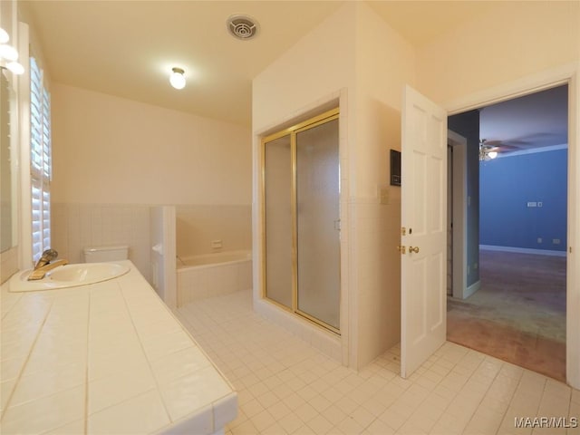 bathroom featuring a sink, visible vents, tile patterned floors, a stall shower, and a garden tub
