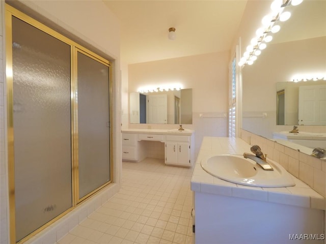 bathroom featuring a sink, a wainscoted wall, two vanities, tile patterned floors, and a shower stall