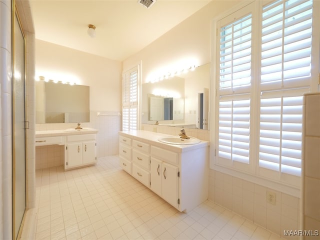 bathroom featuring vanity, tile walls, and tile patterned flooring