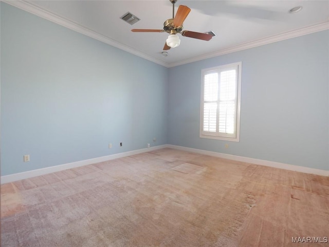 carpeted empty room with crown molding, visible vents, baseboards, and a ceiling fan