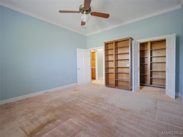 unfurnished bedroom with light carpet, crown molding, a closet, and ceiling fan