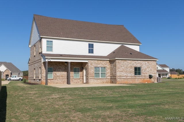 rear view of property with a patio, central air condition unit, and a lawn