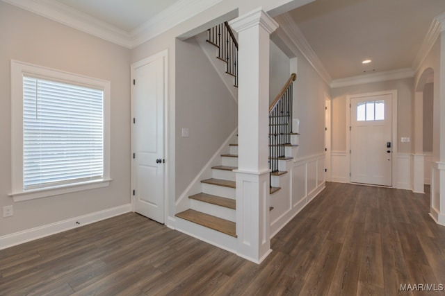 entryway featuring ornamental molding and dark hardwood / wood-style flooring