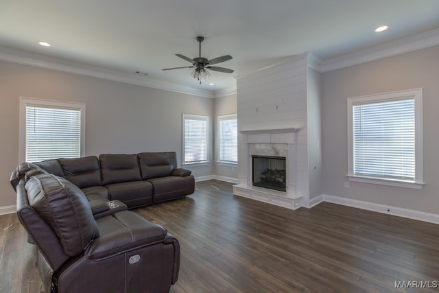 living room with ceiling fan, crown molding, dark hardwood / wood-style flooring, and a fireplace