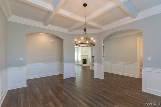 unfurnished dining area with dark hardwood / wood-style flooring, ornamental molding, beamed ceiling, a notable chandelier, and coffered ceiling