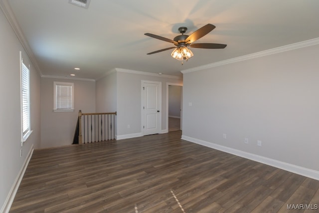 spare room featuring ornamental molding, dark wood-type flooring, and ceiling fan