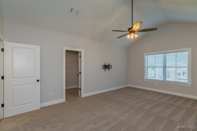 carpeted empty room with lofted ceiling and ceiling fan