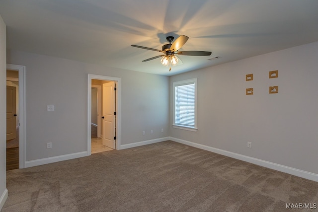 carpeted empty room featuring ceiling fan