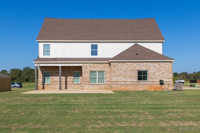 back of house featuring a yard and a patio