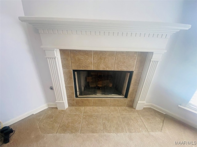 room details featuring a fireplace and tile patterned flooring