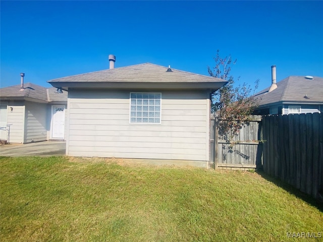 rear view of property with a yard