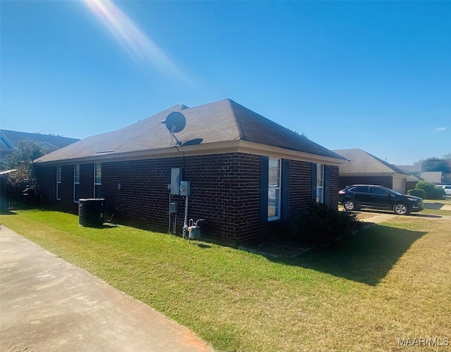 view of home's exterior with central AC and a lawn