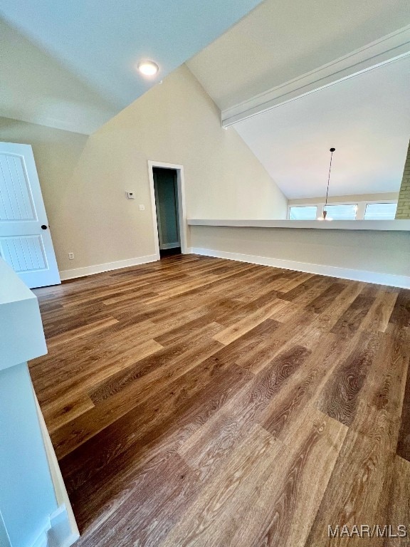 interior space featuring vaulted ceiling with beams and hardwood / wood-style flooring