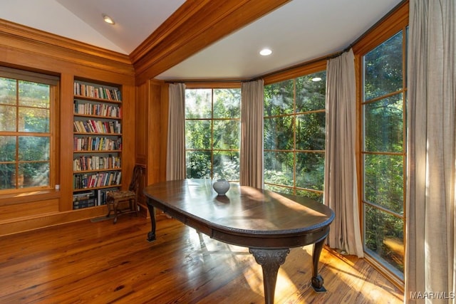 interior space featuring wood-type flooring, vaulted ceiling, built in features, and plenty of natural light