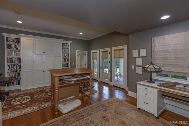 home office with crown molding and light hardwood / wood-style floors