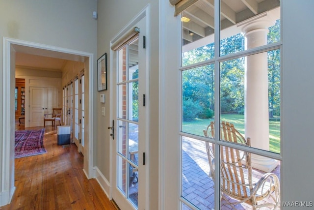 hallway with hardwood / wood-style floors