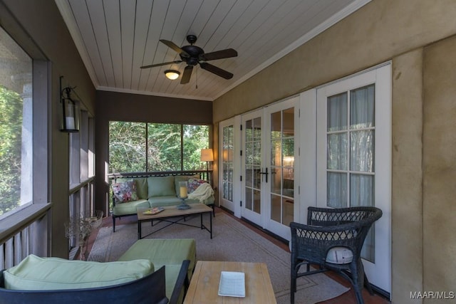 sunroom featuring a healthy amount of sunlight, wooden ceiling, ceiling fan, and french doors