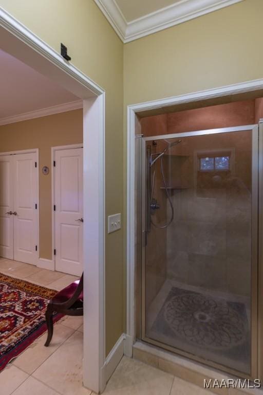 bathroom with an enclosed shower, crown molding, and tile patterned floors