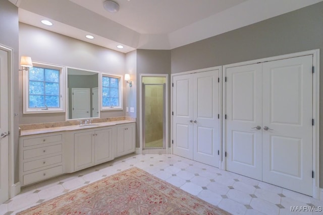 bathroom featuring vanity and a shower with door