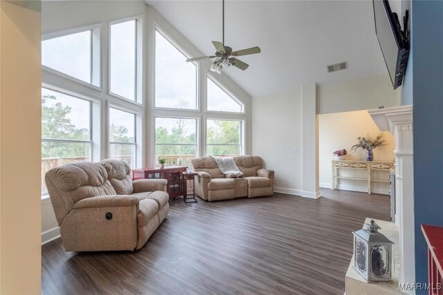 living room featuring ceiling fan, high vaulted ceiling, and dark hardwood / wood-style floors