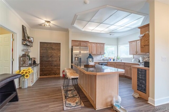 kitchen with stainless steel appliances, wine cooler, dark hardwood / wood-style floors, crown molding, and a breakfast bar area