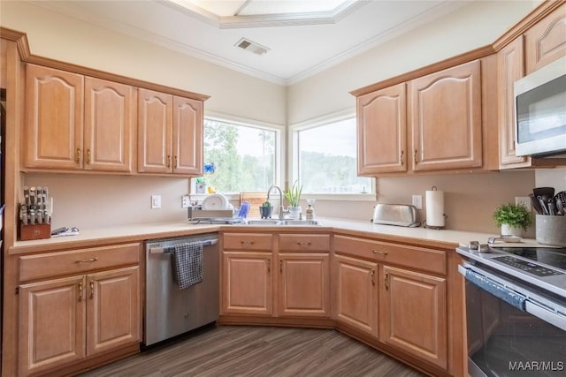 kitchen featuring stainless steel appliances, a sink, visible vents, light countertops, and crown molding