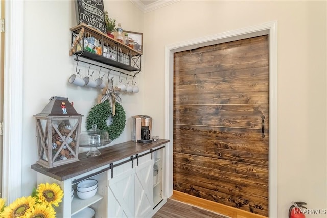 interior space featuring ornamental molding and wood finished floors