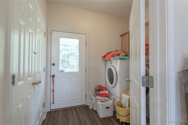 clothes washing area featuring washer / dryer, cabinet space, and wood finished floors