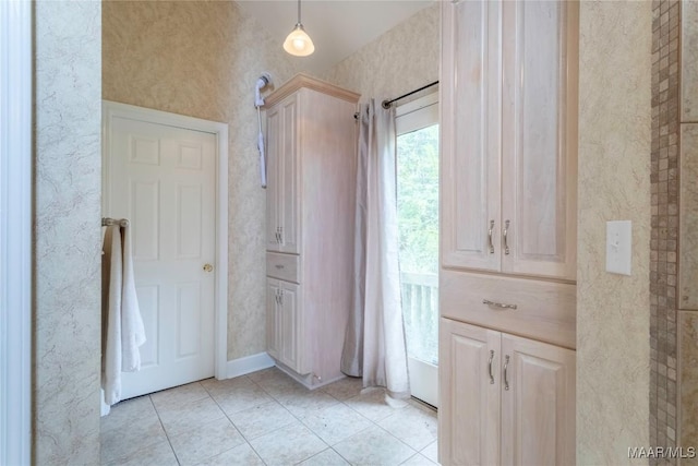 hall with light tile patterned floors