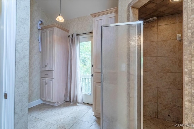 bathroom with tile patterned flooring and tiled shower