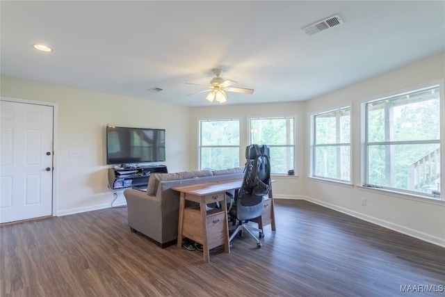 living room with plenty of natural light, dark hardwood / wood-style floors, and ceiling fan