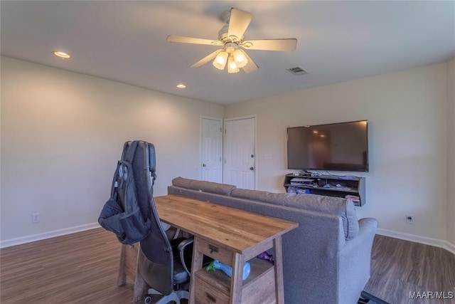 office with ceiling fan, wood finished floors, visible vents, and baseboards