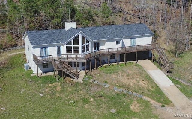 1331 Harrogate Springs Rd, Wetumpka, AL 36093 - back of property with stairway, a chimney, a deck, and concrete driveway