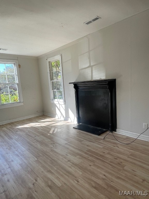 unfurnished living room with light hardwood / wood-style flooring