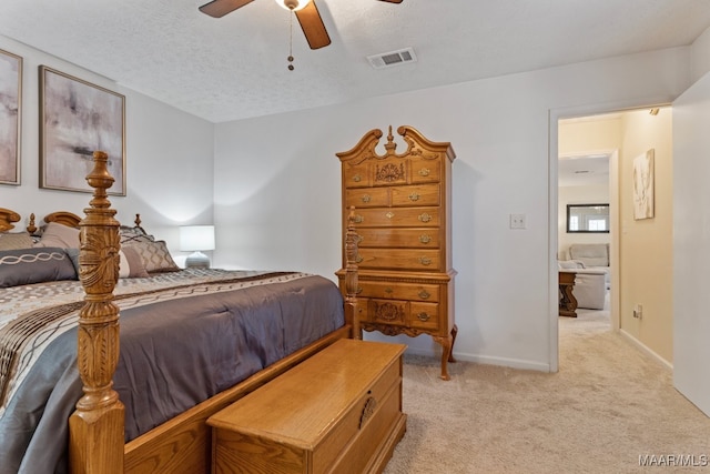 carpeted bedroom featuring a textured ceiling and ceiling fan