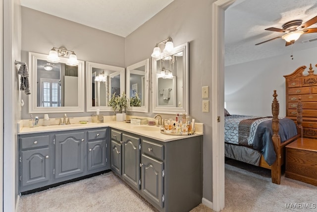 bathroom featuring ceiling fan, vanity, and a textured ceiling