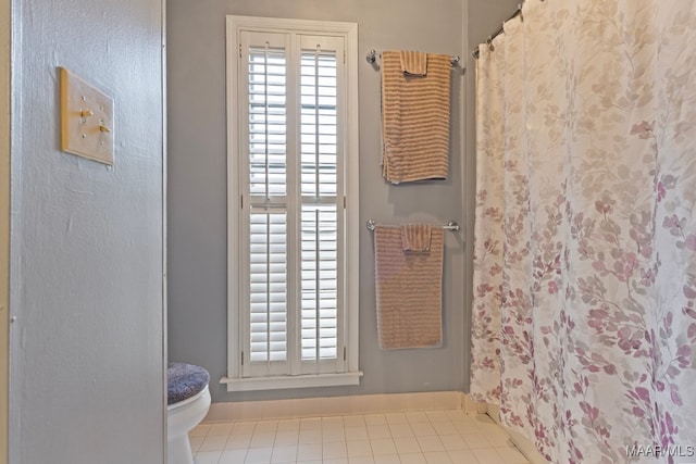 bathroom featuring tile patterned flooring and toilet