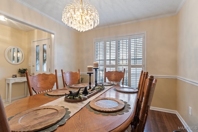 dining space featuring a chandelier, a textured ceiling, crown molding, and dark wood-type flooring