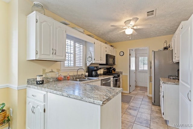 kitchen with sink, white cabinets, a healthy amount of sunlight, and appliances with stainless steel finishes