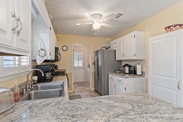 kitchen featuring white cabinets, a wealth of natural light, and sink