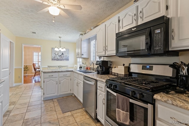 kitchen with white cabinets, sink, a textured ceiling, appliances with stainless steel finishes, and kitchen peninsula